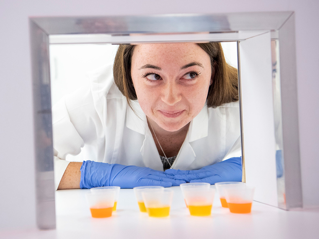 Student in sensory lab with food samples.