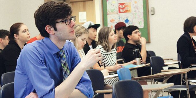 Student in classroom looking at professor.
