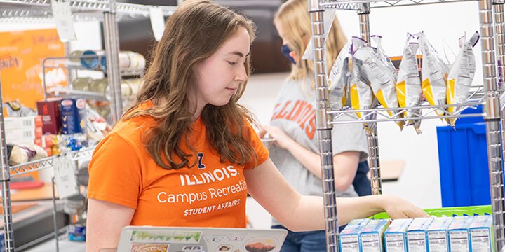 Student stocking food in store.