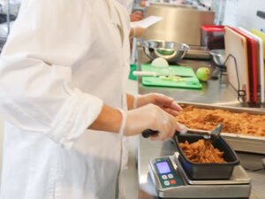 Student measuring food.