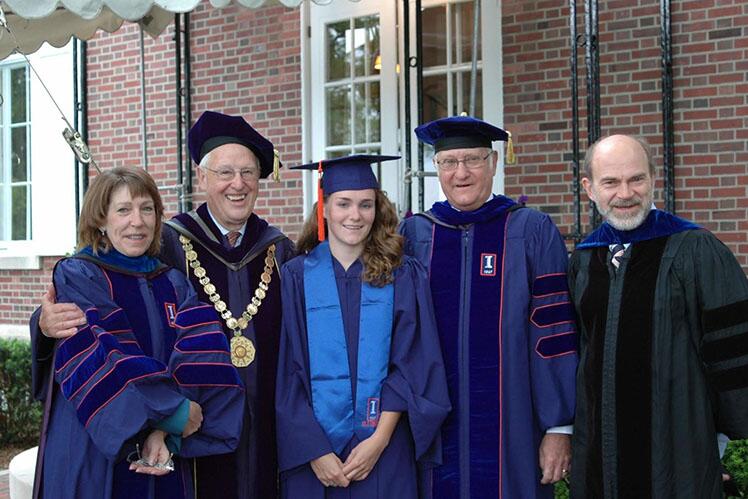 Graduates and professors in graduation robes.