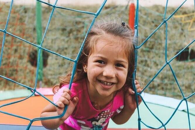 little girl on playground equipment