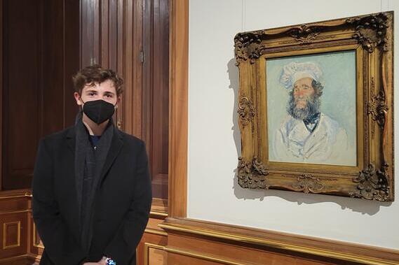 Slojkowski standing next to picture of a chef