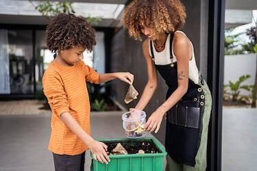 Family tending to their compost bin